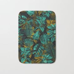 a bath mat with tropical leaves on it