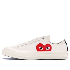 If you're looking for a classic sneaker with a modern twist, you'll love the Comme des Garçons x Chuck Taylor 1970 Low 'Play'. This special edition colorway was designed by graphic artist Filip Pagowski and Comme des Garçons founder Rei Kawakubo, and features a Milk canvas upper with an oversized signature CDG red hear White High-top Skate Shoes With Logo, White Logo High-top Skate Shoes, White Casual High-top Sneakers With Logo, Casual Custom Sneakers With Logo And Round Toe, Custom Casual Sneakers With Logo And Round Toe, Modern White Sneakers With Gum Sole, Casual White Sneakers With Logo, Modern White High-top Canvas Shoes, Modern Converse Sneakers With Rubber Sole