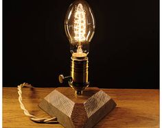 a light bulb sitting on top of a wooden block