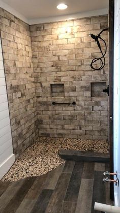 a walk in shower sitting inside of a bathroom next to a wall mounted faucet