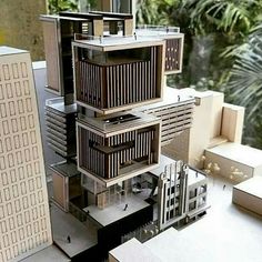 a model of a building in the middle of a city with tall buildings and palm trees