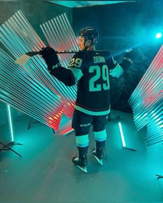 a hockey player is standing in front of some lights