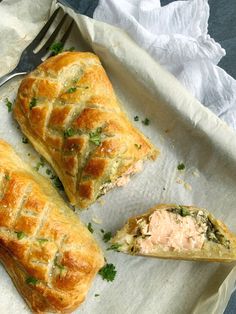 two pastries sitting on top of a white plate next to a knife and fork