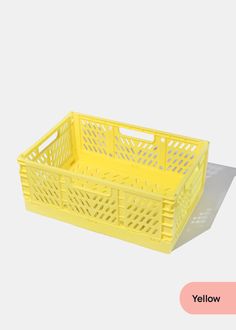 a yellow plastic crate sitting on top of a white floor