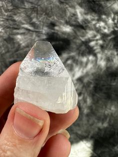 a person holding a piece of crystal in their hand