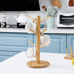 a kitchen with blue cabinets and white countertops has an apple on the table next to it