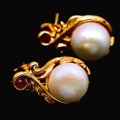 Gorgeous Natural White Pearl Art Nouveau Estate Earrings Each earring features a natural creamy white 9mm pearl in an elegant art nouveau setting, topped with a tiny red ruby! They have pushback closures for pierced ears.  The setting is lustrous 18k yellow gold over sterling silver.  Each earring measures 11.3 x 17.3 mm. Although vintage, from an estate, these earrings are in excellent condition. They would make a great gift OR a wonderful addition to your personal collection!  They will come t Gift White Hallmarked Pearl Earrings, White Cabochon Earrings For Anniversary, Formal Gold Pearl Earrings With Gemstone, Gold Pearl Earrings With Gemstones For Formal Events, Gold Pearl Earrings With Gemstone For Formal Occasions, Classic Gold Pearl Earrings With Gemstone, Classic Pearl Gemstone Earrings As Gift, Classic Pearl Earrings With Gemstone For Gift, Red Ruby Earrings