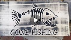 a sign that says gone fishing with a fish in it's mouth and the words gone fishing written on it