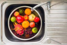 a sink filled with lots of different types of fruit