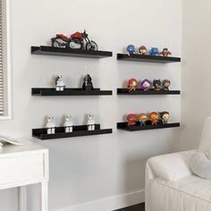 a living room filled with furniture and lots of shelves on the wall next to a white couch