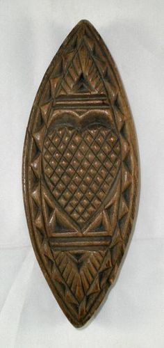 an ornate wooden plaque with geometric designs on it