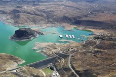 an aerial view of a large lake surrounded by mountains