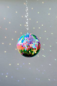 a multicolored disco ball hanging from a chain