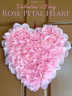 a heart made out of tissue paper on the front door with words valentine's day rose petal heart