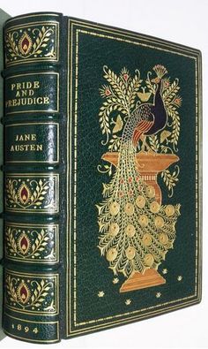 the book is green with gold trimmings and an image of a peacock on it