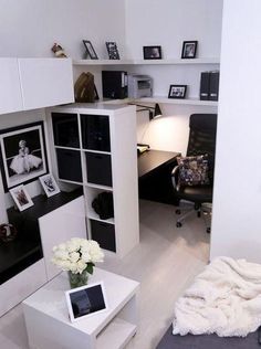 a room with white furniture and pictures on the wall, including a desk in the corner