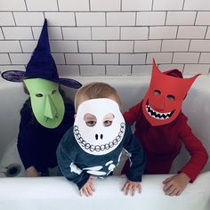 three children in halloween costumes sitting in a bathtub with masks on their faces and mouths