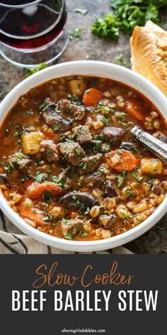 slow cooker beef and barley stew in a white bowl with bread on the side