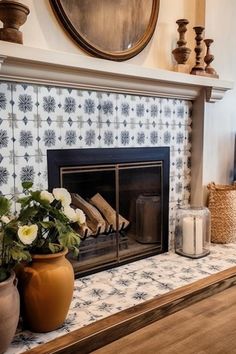 a fireplace in a living room with vases and flowers on top of the mantle