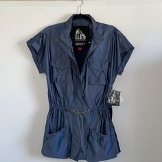 Nwt G.E.T Windbreaker Short Sleeve Blue Jacket -Size S -Zip-Up, As Well As Button Up -4 Front Pockets (2 On The Chest, 2 By The Waist) - Adjustable Waist Strings -Zipper On The Back Of Collar -Condition Is New With Tags Blue Utility Top For Spring, Blue Utility Tops For Spring, Blue Casual Utility Jacket For Outdoor, Casual Navy Utility Jacket For Spring, Zip Up Jacket, 2 On, Blue Jacket, Zip Ups, Button Up