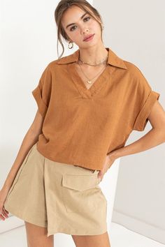 Experience everyday elegance with our Always a Delight Short Sleeve Linen Top. This top exudes understated sophistication with its collared V-neck and cuffed short sleeves, all anchored by a relaxed bodice for effortless style. Pair it with cargo shorts for a casual yet refined ensemble that's perfect for any occasion. Summer Blouses For Women Casual, Casual Crop Top Outfits, White Jumpsuit Dress, Weekend Fashion, Everyday Elegance, Cuffed Sleeve, Fashion District, Soft Autumn, Fall Capsule Wardrobe