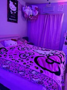 a bedroom with hello kitty bedding and purple curtains