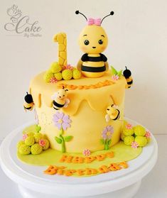 a yellow cake decorated with bees and flowers