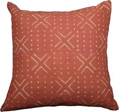 an orange pillow with white dots and lines on the front, against a white background