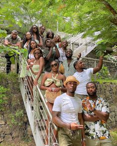 a group of people posing for a photo on a bridge