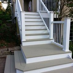 a white porch with steps leading up to the front door