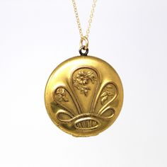 Stunning antique gold filled crown-like motif Art Nouveau locket with floral accents! The backside of this early 1900s locket is engraved with initials that look like they could be EPV. The inside of locket has original photos, bezels, and lucite covers. The locket is modeled on a 20 inch gold filled chain. ERA - Circa 1900s - Art Nouveau  METAL / MATERIAL - Gold filled locket, 14k gold filled chain, photographs   MARKINGS / HISTORY - Chain is marked "14/20 GF"  CONDITION - Good antique condition. Gold filled metal has been professionally polished & cleaned. Age appropriate patina & wear remains. Photos are well preserved. SIZE / MEASUREMENTS - Chain Modeled: 20 inches, Pendant (including bail): 1 1/2 x 1 1/4 inches, Weight (without chain): 11.6 grams PRESENTATION - Listing includes a comp Victorian Filigree Locket Necklace In Yellow Gold, Victorian Filigree Yellow Gold Locket Necklace, Victorian Yellow Gold Medallion Locket Necklace, Victorian Yellow Gold Locket Necklace With Filigree, Ornate Yellow Gold Medallion Locket Necklace, Victorian Yellow Gold Locket Necklace, Antique Yellow Gold Locket Necklace, Victorian Style Yellow Gold Locket Necklace, Vintage Gold Locket Jewelry