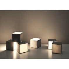 four cubes sitting on top of a table next to each other