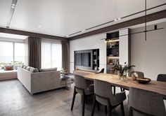 a living room filled with furniture and a flat screen tv on top of a wooden table