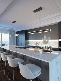 a modern kitchen with marble counter tops and bar stools