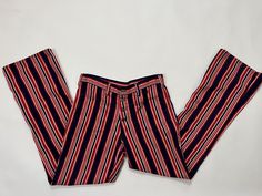 Vintage 1970's Red, White and Blue hip hugger pants. Light-weight denim with a vertical stripe. Two front pockets. Button Fly. Slightly distressed, these is a hand-sewn patch on the knee and a darn repair on the back of the leg. Overall color is faded due to age and some areas are a little bit more faded than others. Perfect for summertime as the denim is on the thinner side. In good condition despite flaws. Please see all photos & measurements, pants are being sold as-is. M E A S U R E M E N T S.  measured laying flat    Waist: 16 inches   Hip: 19 inches Rise: 11.5 inches Inseam: 31.5 inches Width across thigh: 11.5 inches Width across calf: 8.25 inches Length: 42 inches  Material:  cotton Size:  32" waist/ medium Label:   n/a Please see Shop Policies before committing to purchase.   ALL Retro High Waist Striped Bottoms, Retro High Waist Striped Pants, Retro Cotton Pants With Vertical Stripes, Retro Striped Fitted Bottoms, Vintage Striped Wide Leg Bottoms, Striped Flare Jeans, Stripe Flare Jeans, Retro Striped Denim Bottoms, Vintage Striped Straight Leg Bottoms