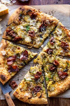 a pizza cut into eight slices on top of a cutting board with cheese and other toppings