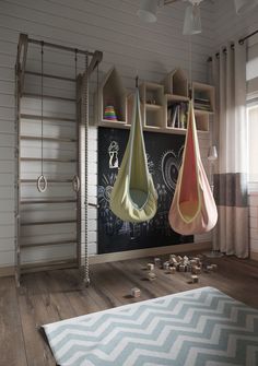 a child's room with two hanging toys and a chalkboard in the background