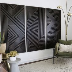 a living room with three decorative panels on the wall