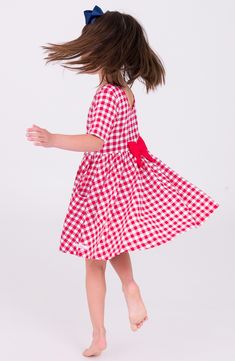 A sweet bow at the back accents a twirly, easy-fitting dress made from soft cotton jersey in a picnic-and-parade-ready gingham check. Slips on over head Front scoop pockets 95% cotton, 5% spandex Machine wash, tumble dry Imported Gingham Plaid Cotton Dress With Ruffles, Gingham Maternity Dress, Gingham Cotton Dress With Lace Trim, Playful Gingham Dress For Playtime, Gingham Plaid Knee-length Dress With Ruffles, Fitting Dress, Red Gingham, Gingham Check, Nordstrom Dresses