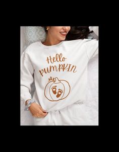 Hello Pumpkin Pregnancy Sweater, Hello Pumpkin Pregnancy Announcement Sweatshirt, Fall Pregnancy Shirt, Fall Pregnancy hoodie, Halloween Baby Key Features: This super cute "Hello Pumpkin" sweatshirt is the perfect way to announce your fall pregnancy. With Halloween and Thanksgiving just around the corner, this maternity sweater is a fun and festive way to share the news with friends and family. Surprise your wife or loved one with this unique baby reveal gift and watch her glow with joy. Celebrate your growing family this fall with this adorable fall pregnancy announcement crewneck. Easy Care: Machine cold wash, inside out, with like colors. Only non-chlorine bleach. * 50/50 pre-shrunk cotton/ polyester  * 100% U.S. Ethically Grown Cotton * These are unisex sweatshirts and therefore have a White Family Matching Sweatshirt For Fall, White Long Sleeve Tops For Gender Reveal, Pregnancy Sweater, Pumpkin Pregnancy Announcement, Fall Pregnancy, Fall Pregnancy Announcement, Pumpkin Sweatshirt, Fall Maternity, Pumpkin Sweatshirts