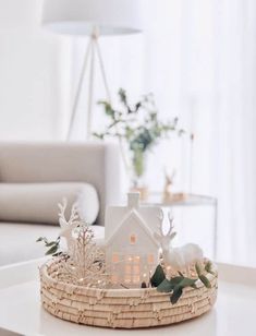 a small white house sitting on top of a table