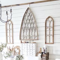 a living room filled with furniture and decor on top of a wooden floor covered in white paint