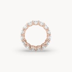 a rose gold ring with white diamonds on the inside and outside, set in 18k rose gold