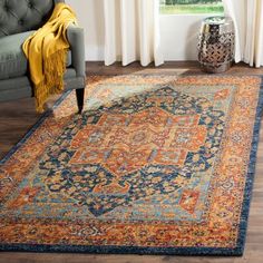 a living room with a couch, chair and rug