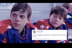 two young men sitting next to each other wearing hockey jerseys and looking at the camera