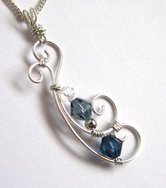 a silver necklace with two blue glass beads