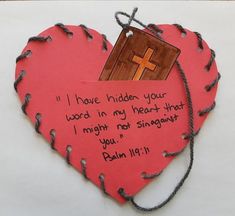 a paper heart with a cross on it and a note attached to the side that says, i have hidden your word in my heart that i might not sing