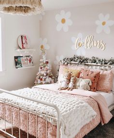 a bedroom decorated for christmas with pink and gold decor