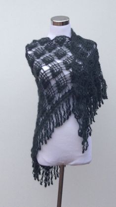 a white mannequin wearing a black lace shawl