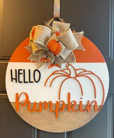 a door hanger that says hello pumpkin on it, with a bow hanging from the front